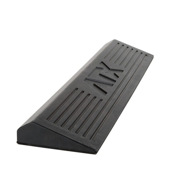 The ATX® Calf Block is a black rubber doorstop featuring horizontal grooves, a sloped design, and a textured surface for excellent grip and secure placement.