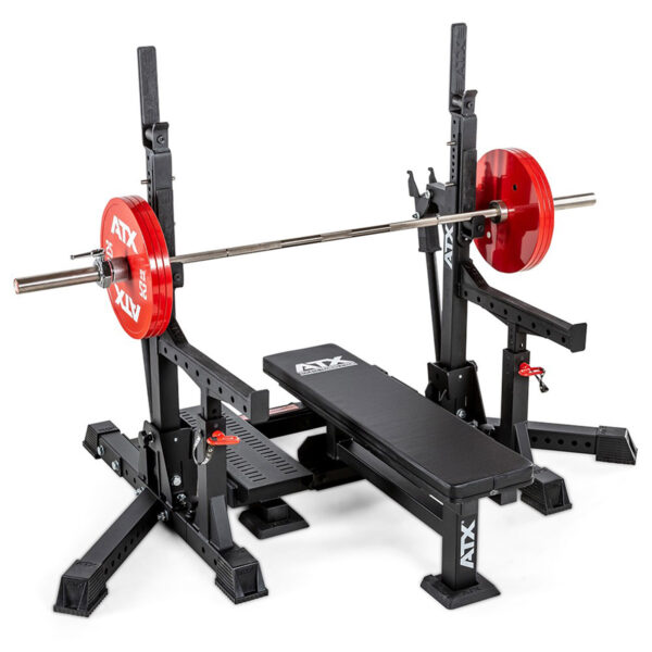 A weightlifting setup featuring the ATX® Competition Combo Rack with a black bench and adjustable barbell holder. A barbell with red plates rests on the rack, all branded with ATX logos.
