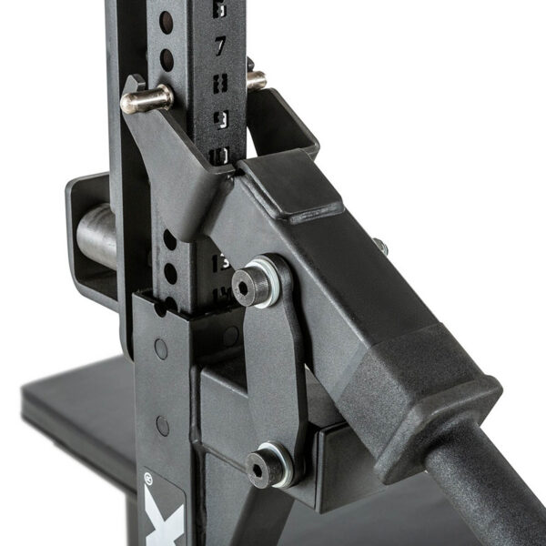 Close-up of the ATX® Competition Combo Rack, a black adjustable weightlifting rack with numbered height settings and secure locking mechanisms. Its sturdy design features a base and metal pegs for securing the barbell.
