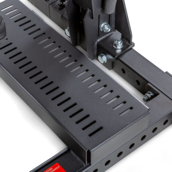 Close-up of the ATX® Competition Combo Racks metal component, showcasing a perforated step plate secured with bolts. It features sturdy construction with rectangular cutouts for grip and ventilation. The dark gray metal includes a small red tag at the bottom left.
