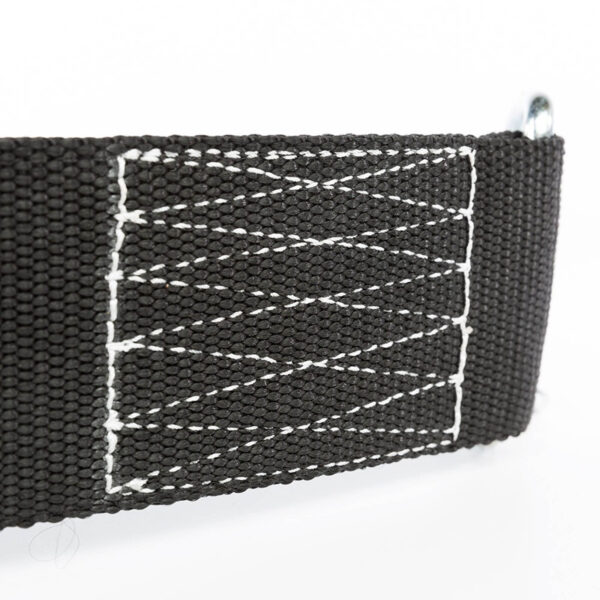Close-up of the ATX® Nylon Dip Belts black strap with zigzag-patterned white stitching, securely attached to a metal loop on the right, all against a clean white background.