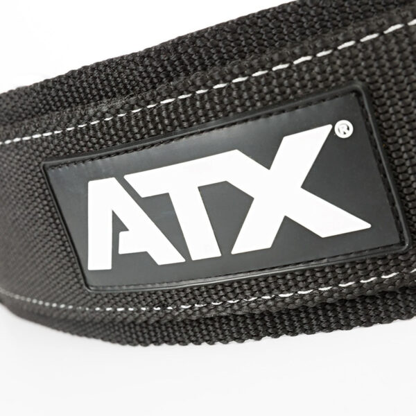 Close-up of the ATX® Nylon Dip Belt, black with white stitching and a rectangular black patch featuring ATX in bold white letters.