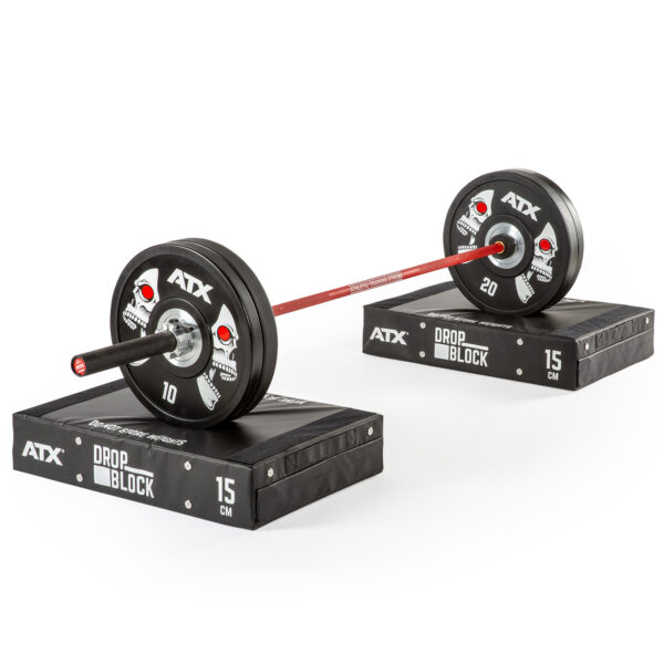 A barbell with 10 and 20 weight plates on each side is placed on two ATX® 15 cm Soft Drop Blocks, set against a white background.