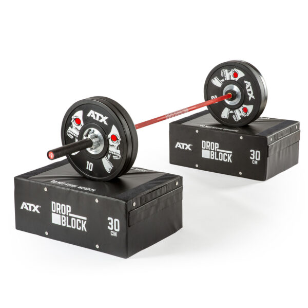 Two barbells with weights rest on ATX® 30 cm Soft Drop Blocks, which are black with white text. The barbells have red sections and weight plates on each end.