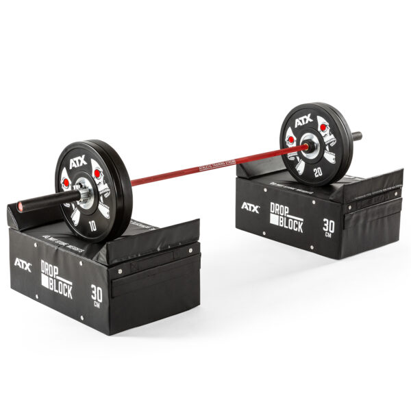 A barbell with 10 and 20 weights on each end is balanced on two ATX® 30 cm Soft Drop Blocks, set against a plain white background.