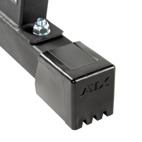 Close-up of a black ATX bar attachment, featuring a notched square end cap, secured with a metallic bolt. Engraved with ATX, its perfect for the ATX® Flat Bench Compact. The surface is smooth and matte.