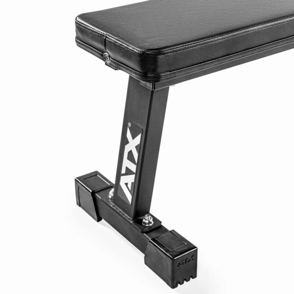 The ATX® Flat Bench Compact, in black with a sturdy metallic frame and ATX logo, is shown close-up on a white background, emphasizing its structural design and padding.
