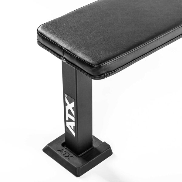A black ATX® Flat Bench PRO features a cushioned top and a sturdy rectangular metal frame, with the ATX logo on its side, set against a white background.