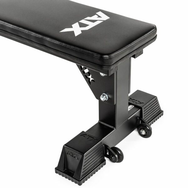 The ATX® Flat Bench is a black weight lifting bench with ATX branding, sturdy metal legs, and two wheels for easy mobility. Ideal for home or gym use, this sleek, modern bench ensures stability and convenience during workouts.