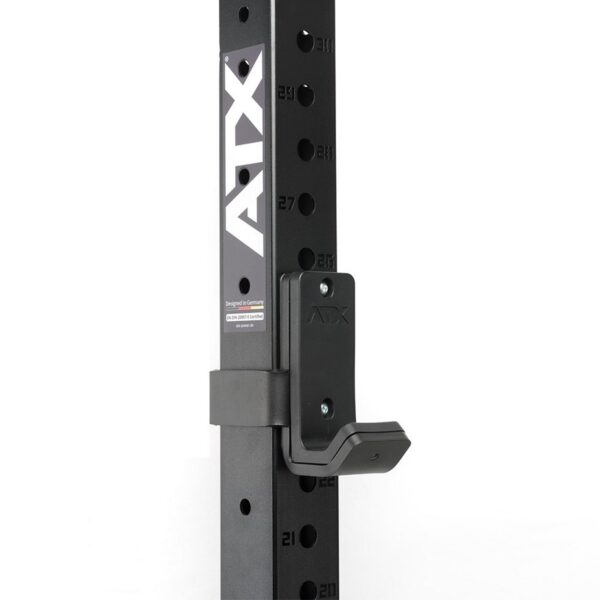 Close-up of a black metal gym rack with ATX vertically on the side. This ATX® J Hooks Compact features adjustable holes numbered 21 to 27 and a J-hook attachment.