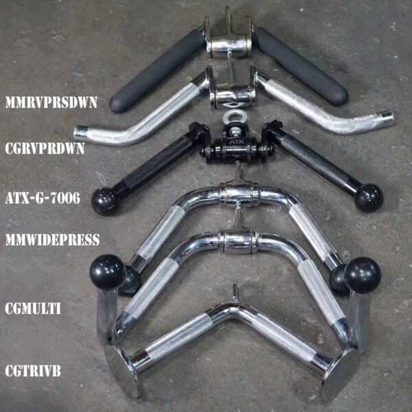 A set of various metal gym attachments is arranged on a gray surface, including the ATX® V Bar Rotational Blackline. Attachments labeled MMRVPRSDWN, CGRVPRDWN, ATX-G-7006, MMWIDEPRESS, CGMULTI, and CGTRIVB include lat pulldown bars and handles with rubber and textured grips.