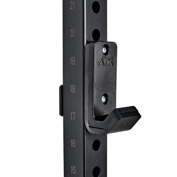 Close-up of the ATX® Wall Mounted Squat Rack in black metal, featuring numbered adjustment holes and a J-hook for weightlifting bars. This rack is sturdy and ideal for gym use.