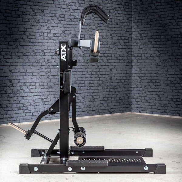 The ATX® Leg Master, ideal for gyms with gray brick walls, features padded handles and adjustable levers on a sturdy metal frame for an optimal leg workout.