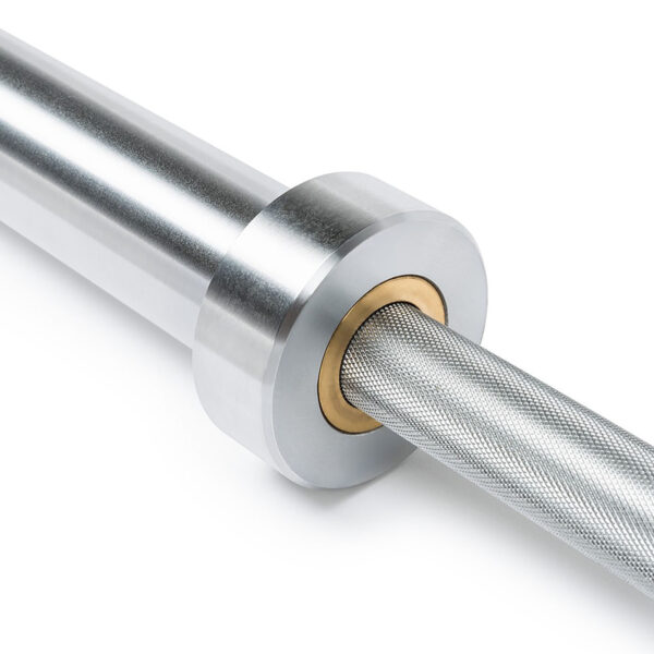 Close-up of the ATX® Olympic Power Barbell with Centre Knurling, highlighting its shiny silver finish, textured grip, and smooth metal sleeves. The barbell is partially visible, showing detailed knurling and sleeve connection.