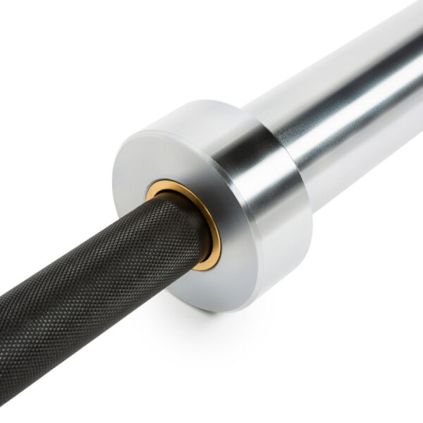 Close-up of The Original ATX® Ram Olympic Power Bar sleeve. The image highlights a textured black bar linked to a smooth, metallic silver sleeve with brass ring detail, set against a plain white background, showcasing its sleek design.