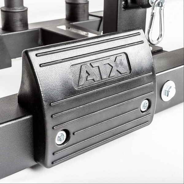 Close-up of a black metal section of the ATX® Lat Option 650 Plate Loaded gym equipment, featuring the engraved letters ATX. The rectangular part shows two bolts on the front against a white background.