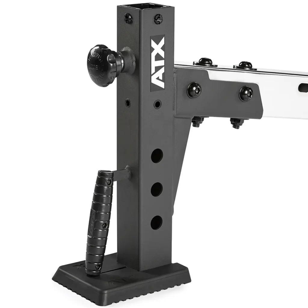 Close-up of the ATX® Multi Bench, a black adjustable gym equipment stand featuring the ATX brand name, handle, and multiple adjustment holes. Its mounted on a flat, textured base for stability.