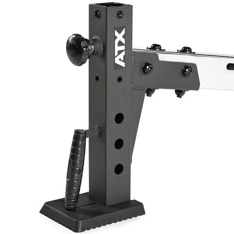 Close-up of the ATX® Multi Bench, a black adjustable gym equipment stand featuring the ATX brand name, handle, and multiple adjustment holes. Its mounted on a flat, textured base for stability.