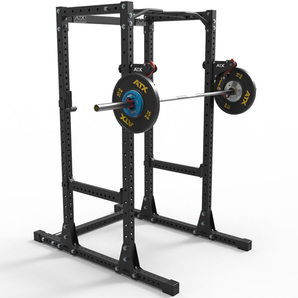 An ATX® PRX Monolift black power rack is set up for a workout, featuring a sturdy frame with multiple holes for adjustable positioning. It includes a loaded barbell with weight plates and collars.