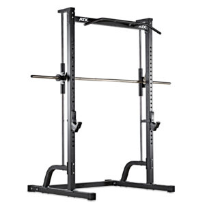 The ATX® Smith Machine Half Rack is a black, free-standing unit with adjustable barbell holders and a pull-up bar. It features multiple height settings for versatile workouts and has a logo at the top.