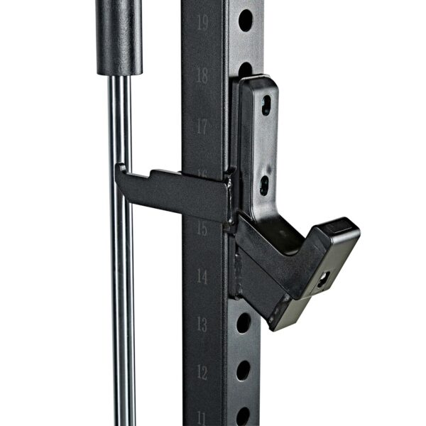 Close-up of the ATX® Smith Machine System Plate Loaded shows an adjustable weight rack with a black metal support arm, marked from 13 to 19. The arm connects to a vertical section with adjustment holes.