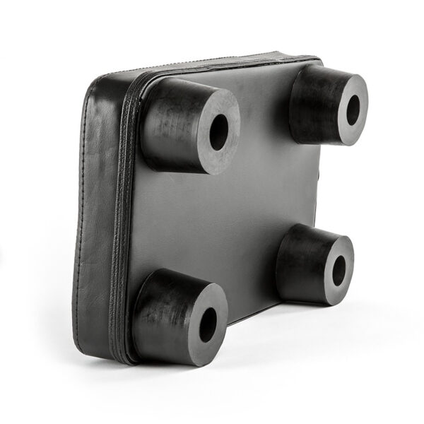 The ATX® Pec Fly Attachment is a black, rectangular leather pad featuring four cylindrical rubber legs at the corners on one edge. It has a smooth texture and is designed to provide support or protection.