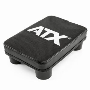 A rectangular black step platform with rounded corners and four short legs has a textured surface and features the ATX® Pec Fly Attachment brand name in prominent white lettering on top.