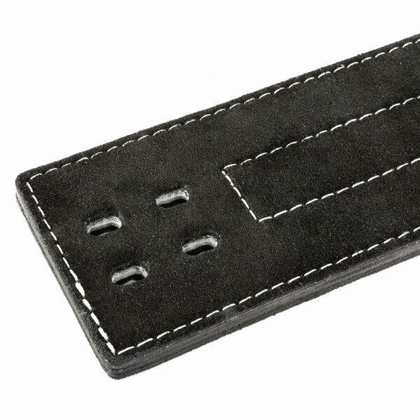Close-up of the ATX® Lever Suede Power Belt in black suede, featuring four small holes and white stitching along the edge. The belt is partially shown, focusing on the end with the holes.