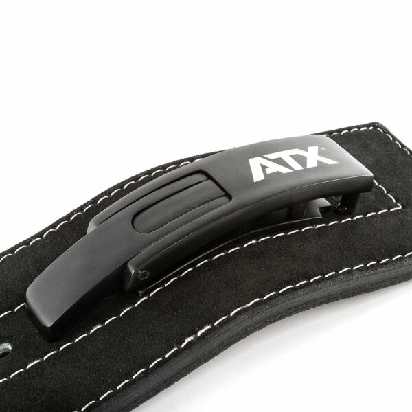Close-up of a black buckle attached to the ATX® Lever Suede Power Belt, featuring a sleek, modern design with a matte finish on the black leather strap adorned with white stitching, all set against a white background.