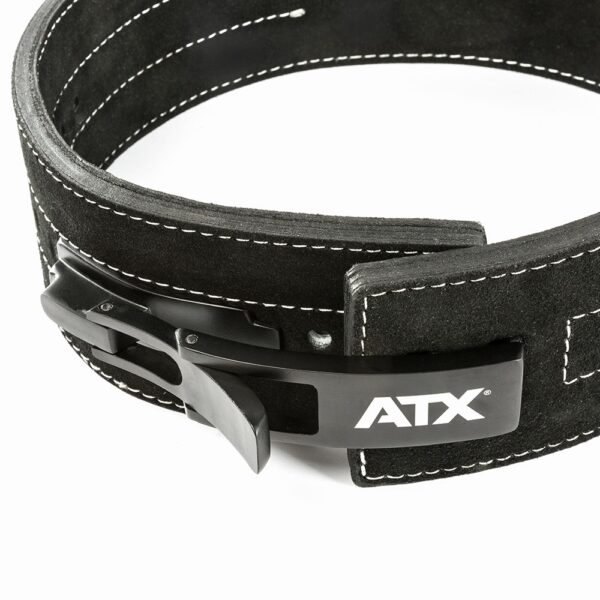 A detailed view of the ATX® Lever Suede Power Belt showcases its sleek black design with white stitching and a prominent lever buckle. The belt displays the ATX logo in white, with both the buckle and stitching standing out against a simple background.