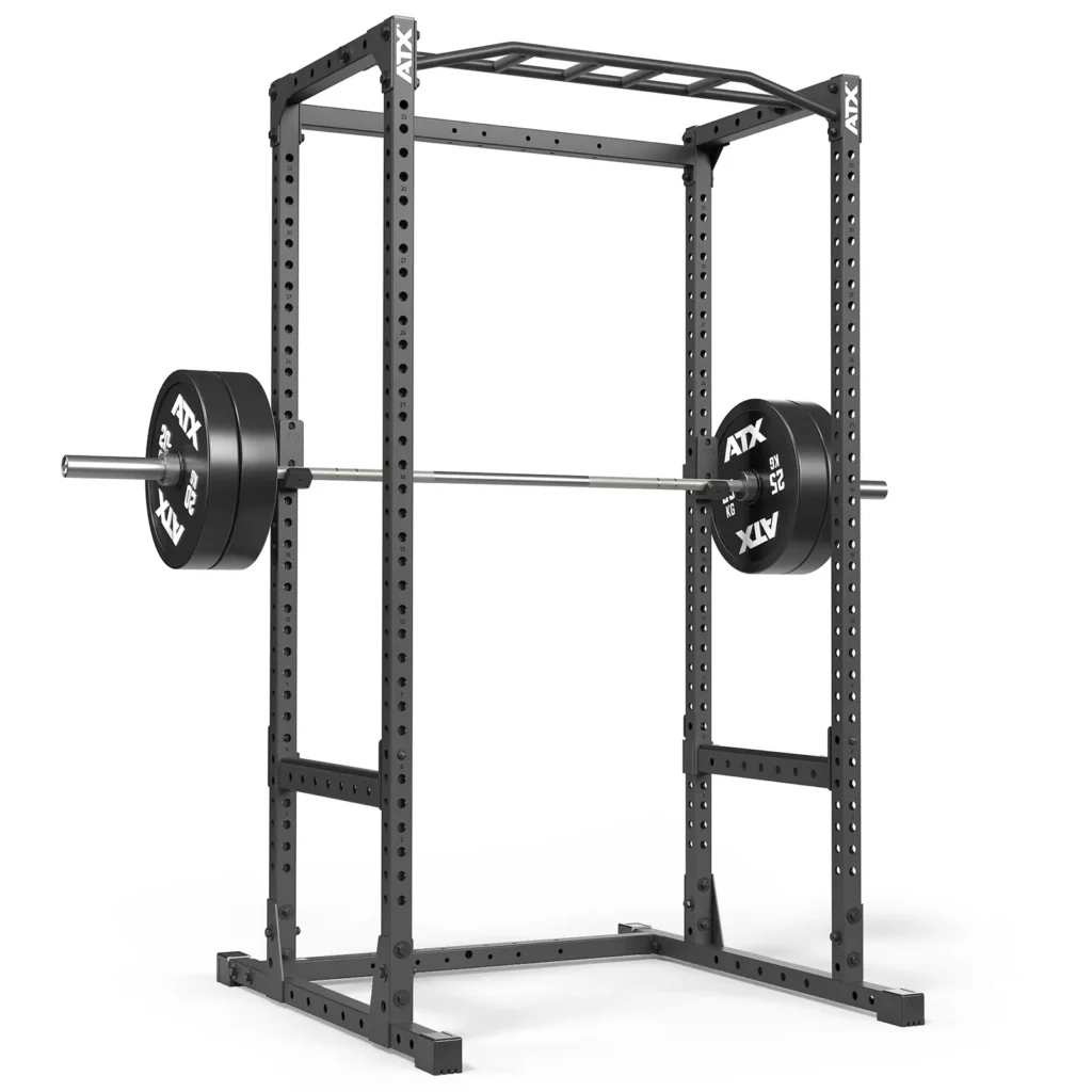 The ATX® Power Rack 520 215cm features multiple adjustable height holes, a pull-up bar on top, and a black frame with a loaded barbell placed on safety pins. The weight plates are labeled ATX and the rack stands against a white background.