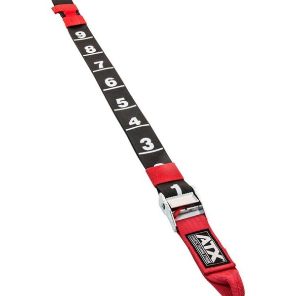 The ATX® Suspension Trainer Set PRO includes a long red strap with a black adjustable section marked 1 to 9, featuring a metal buckle at one end and a red handle at the other. The brand logo is prominently displayed near the buckle.