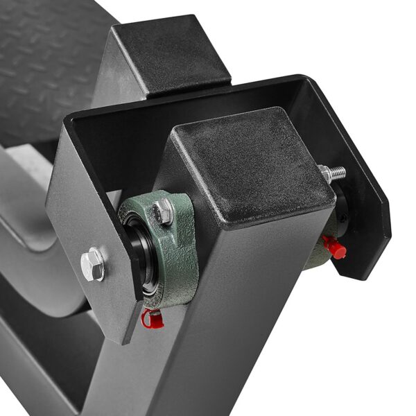 Close-up of a Plate Loaded T-Bar Row machine part with a textured metal surface and bolts. Visible components include the ATX black metal frame and green bearing housings.