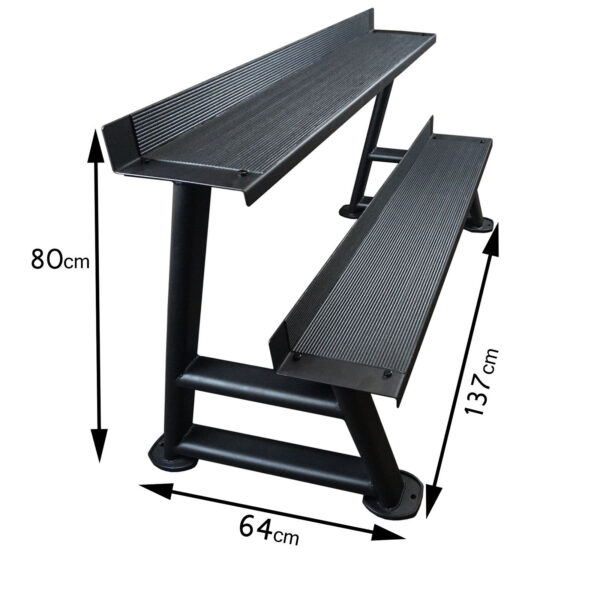 The Power Maxx Kettlebell Rack is a black, two-tier step stand that measures 80 cm in height, 64 cm in width, and 137 cm in length. It features anti-slip surfaces on each step and includes sturdy metal supports for reliable stability.