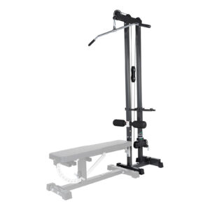The Ironmaster Cable Tower Attachment V2, black and adjustable, is designed for home gyms. It features a padded seat, stabilizing bar, and a long lat pulldown bar. A weight bench is partially visible in the foreground.