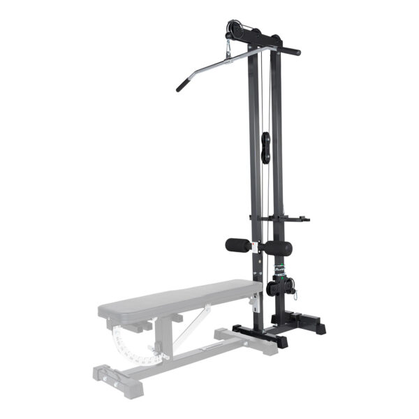 The Ironmaster Cable Tower Attachment V2, black and adjustable, is designed for home gyms. It features a padded seat, stabilizing bar, and a long lat pulldown bar. A weight bench is partially visible in the foreground.