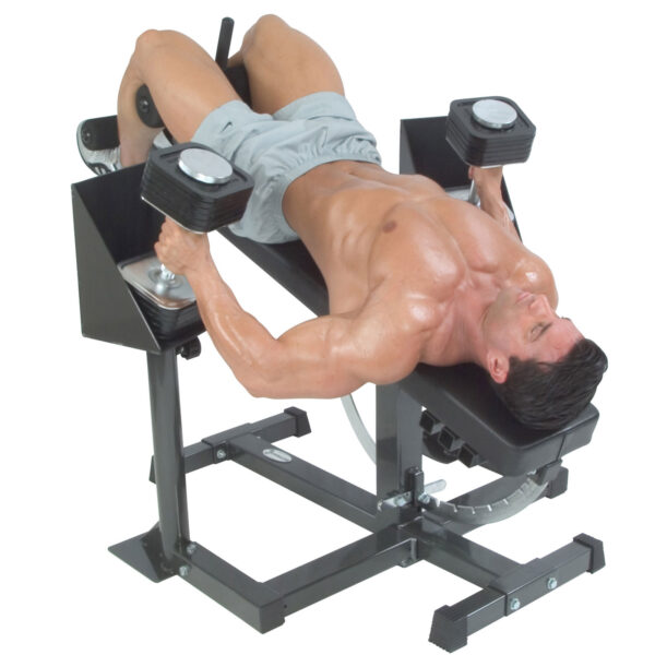 A person, wearing gray shorts and Spud Wrist Wraps Heavy, performs a dumbbell chest press on a decline bench while shirtless, holding a dumbbell in each hand.