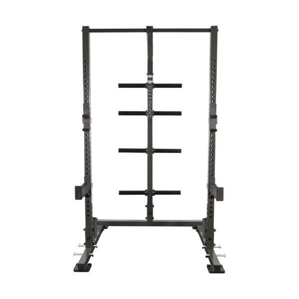 The IM1500 Ironmaster Half Rack is a freestanding squat rack featuring adjustable barbell holders, safety bars, a sturdy metal frame, and multiple weight storage positions on the back.