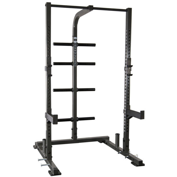 The IM1500 Ironmaster Half Rack is a black power rack featuring adjustable safety bars, multiple weight storage pegs, a top pull-up bar, and adjustable j-cups for barbell support. It is set against a white background.