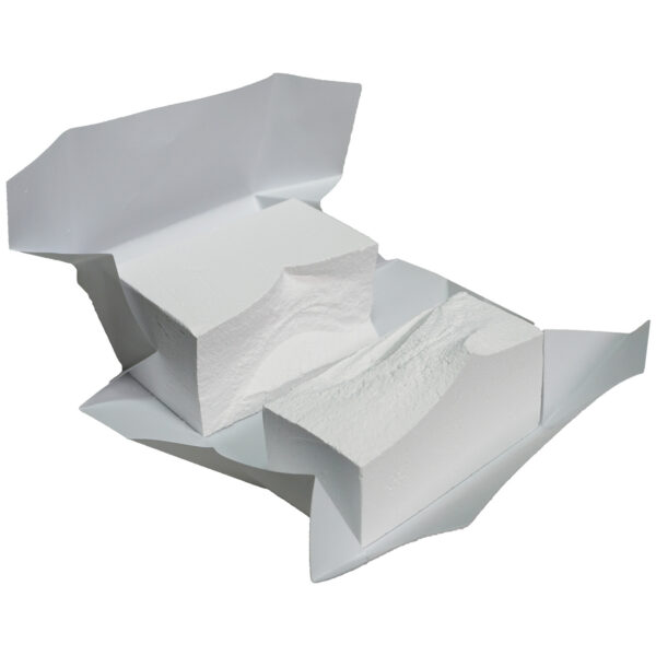 An open package reveals two white, rectangular blocks of soft substance, resembling gym chalk, resting on crumpled white wrapping paper.