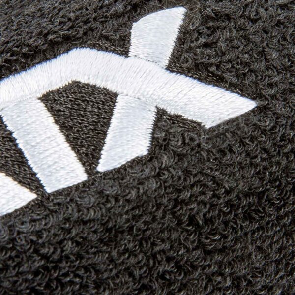 Close-up of black textured fabric on the Kettlebell Wrist Guard with white embroidered letters and a thick, looped surface pattern.