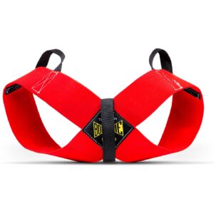 A Spud Inc Bowtie Casual exercise band shaped like a red cross, featuring black handles and a central yellow label set against a white background.