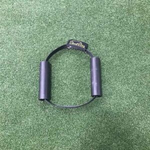 A Spud Inc Hooker Straps workout handle with a rope lies on a green carpet.