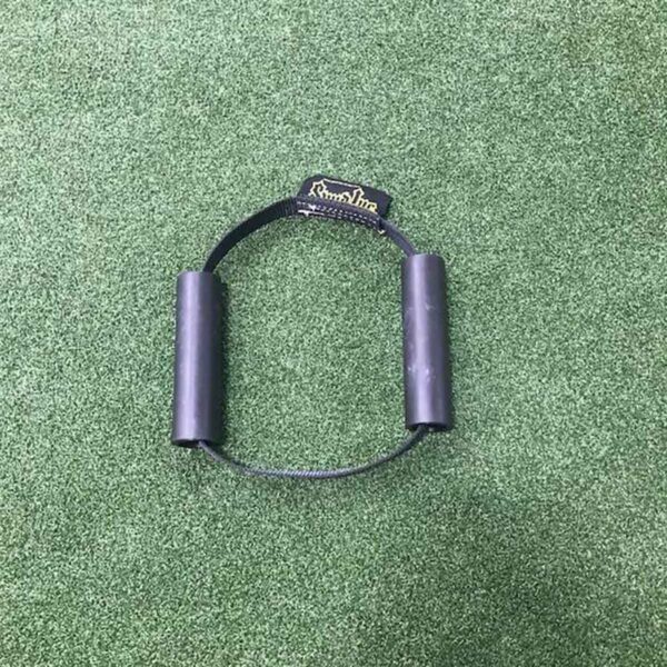 A Spud Inc Hooker Straps workout handle with a rope lies on a green carpet.