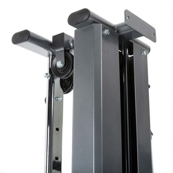 Close-up view of a metallic gym machine part with sleek gray steel columns, black handles, and visible cables and bolts. The design appears sturdy and polished, ideal for strength training on a wall-mounted cable machine.