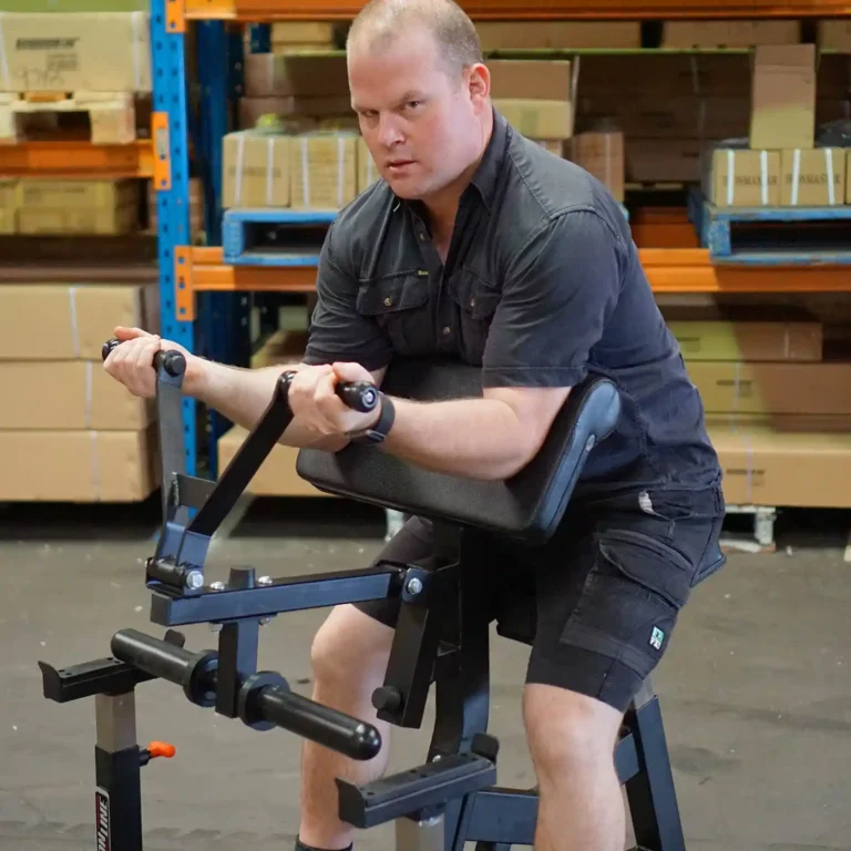 bodybuilder using preacher curl machine