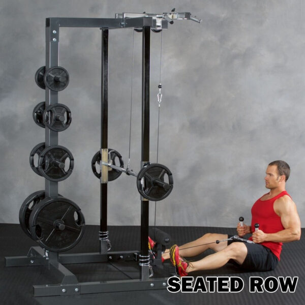 A man in a red tank top and black shorts uses an Ironmaster IM2000 Self-Spotting Smith Machine at a gym. The machine features various weight plates, with a gray background and SEATED ROW boldly displayed at the bottom right.