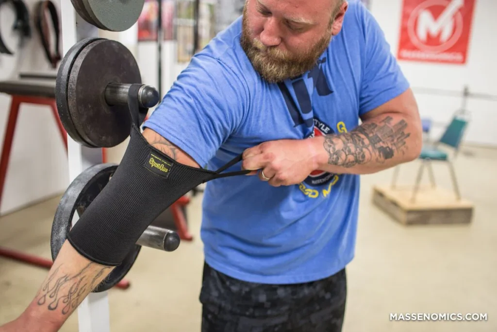 A man slipping on some Spud Elbow Sleeves