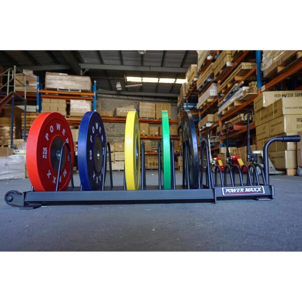 In a warehouse filled with shelves and boxes, Bumper Weight Plate Toaster Racks neatly organize colorful weight plates.