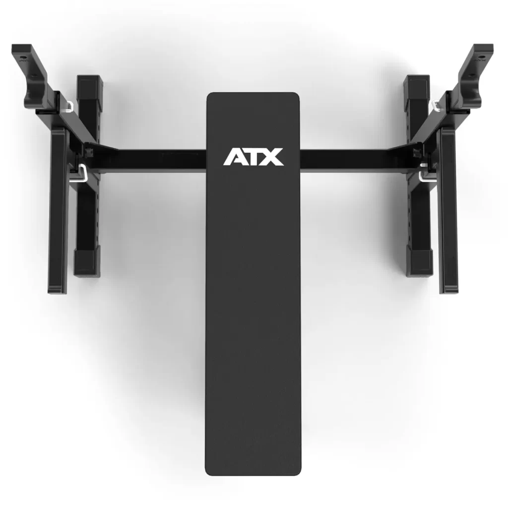 The ATX® Olympic Bench Press 700 is a black, foldable, wall-mounted weight bench designed for space-saving home workout setups, featuring a padded surface and a sturdy metal frame.